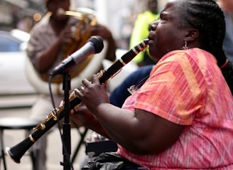 woman using black clarinet
