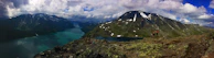 A panoramic mountain vista with hikers pausing to take in the breathtaking scenery.