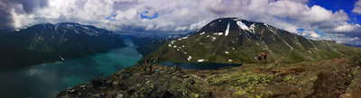 Panoramic view of Morskie Oko lake with a group of hikers equipped with hypershell exoskeletons