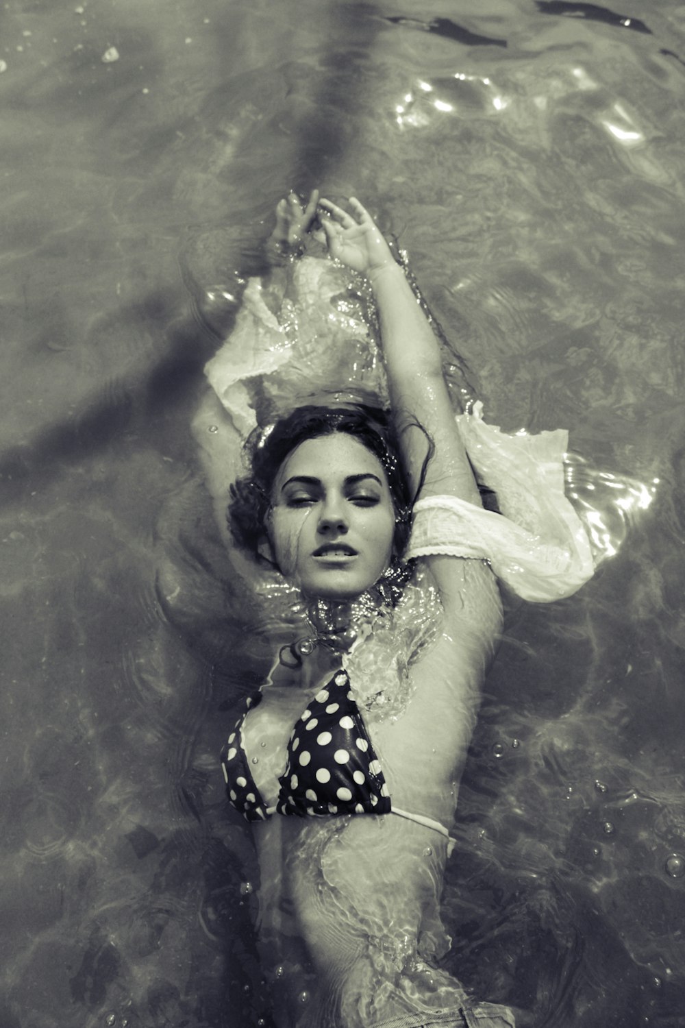 Photographie en niveaux de gris d’une femme nageant