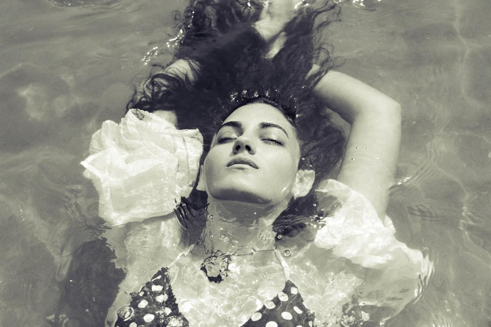 woman in swimwear floating on pool