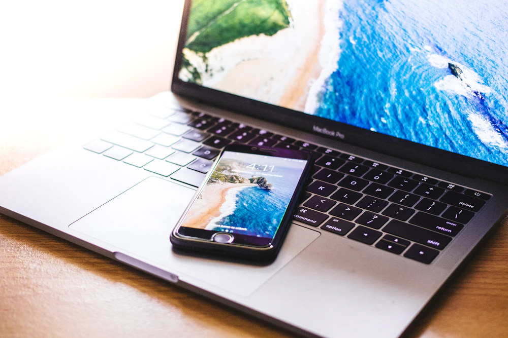 Mira pricing: iPhone resting on a MacBook Pro keyboard