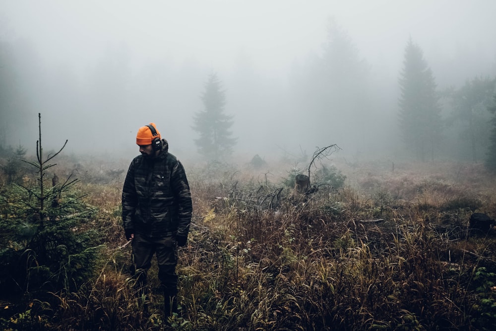 man standing on grass field