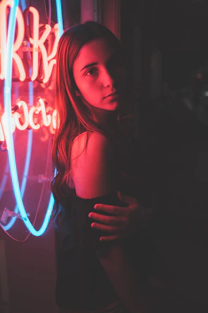 An expressive close-up of a character caught in a moment of temptation under neon city lights.