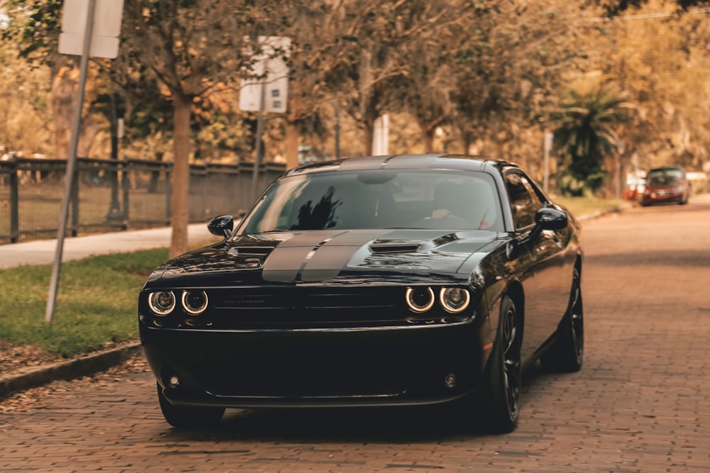 black coupe on concrete road