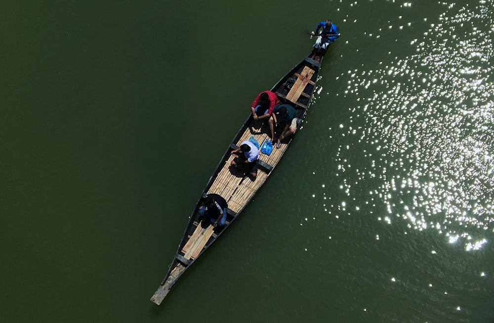 person riding boat on body of water at daytime