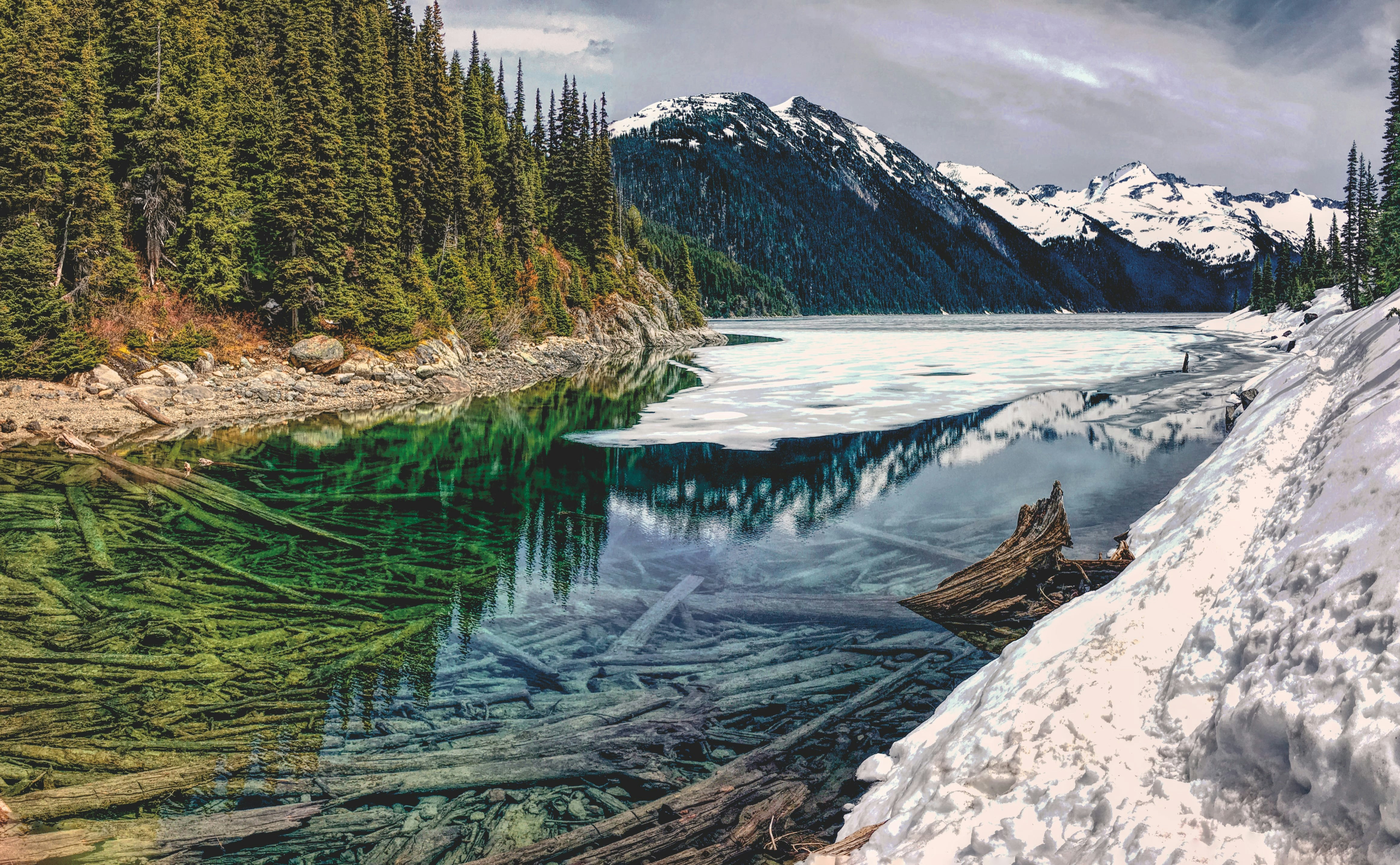 body of water near mountain peak