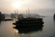 Traditional Sri Lankan boat floating gently on calm lagoon waters at dawn.