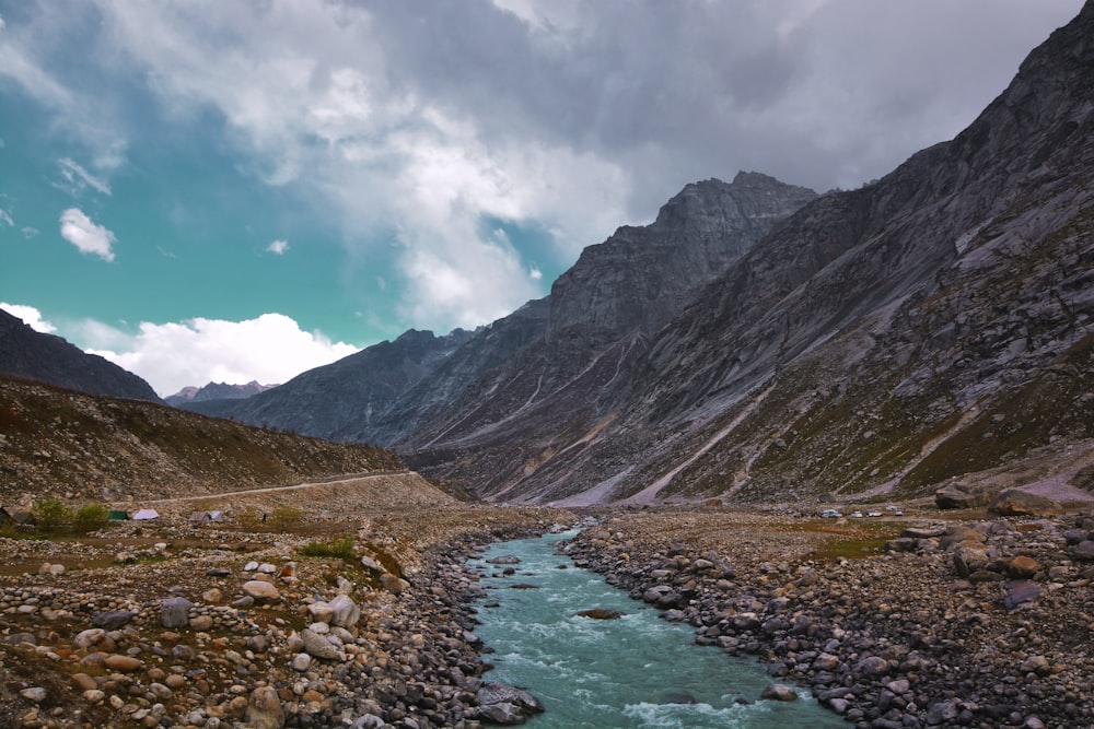 body of water near mountain at daytime