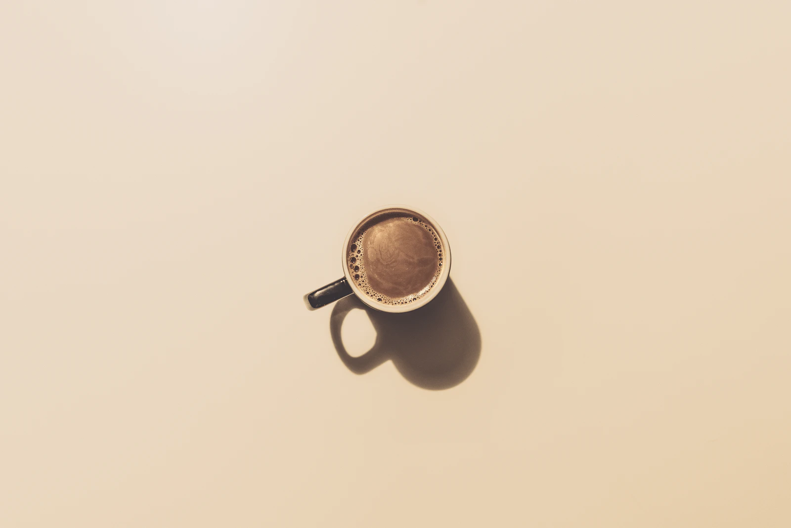 Iced coffee in a glass with warm cafe tones