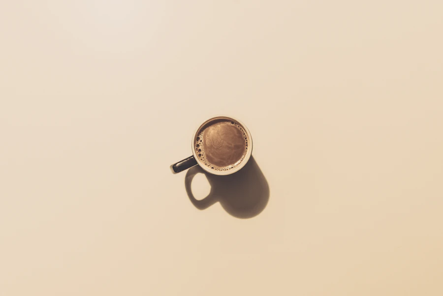 A brown ceramic cup of coffee on a table