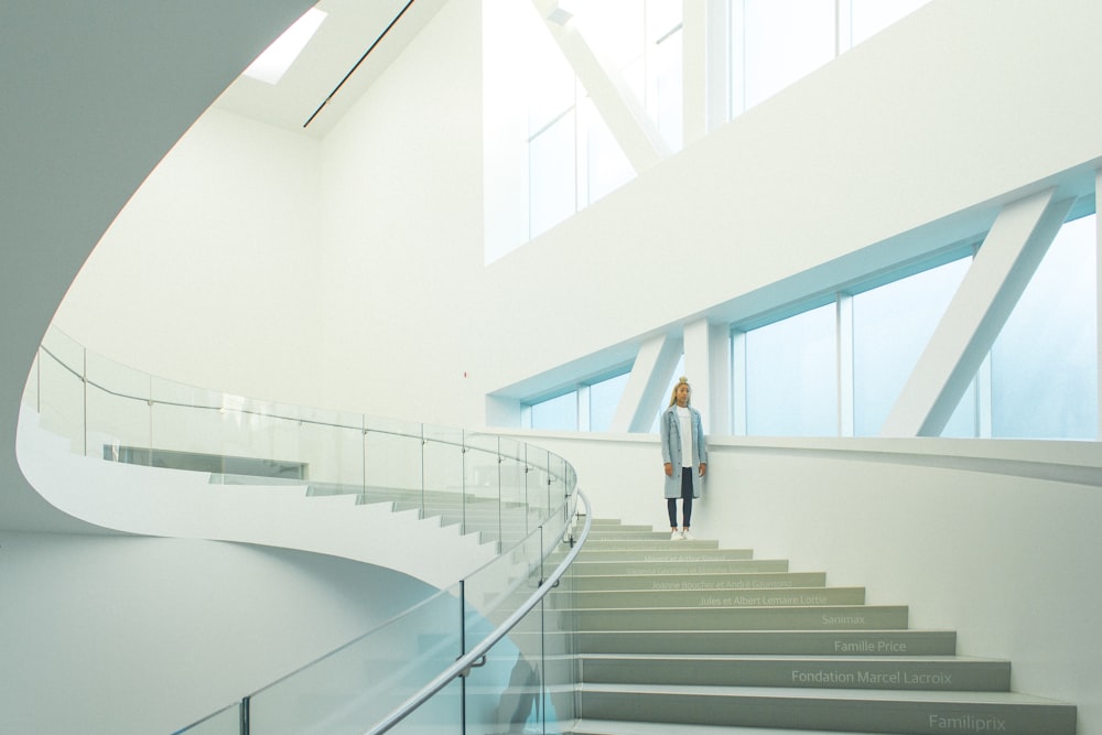 woman standing on staircase near window