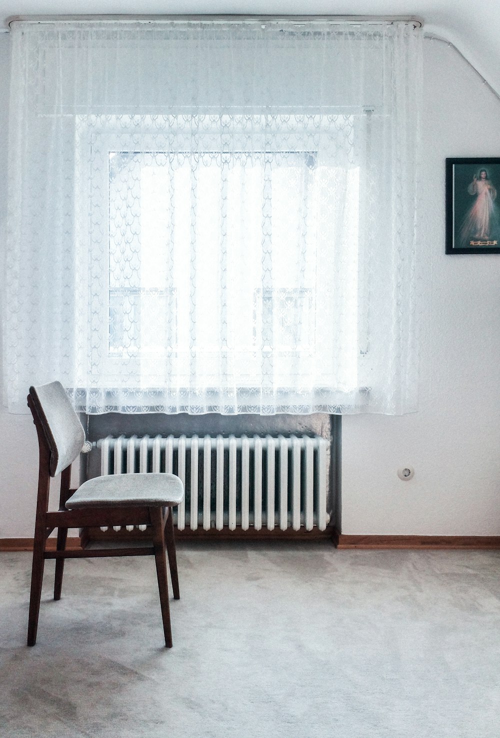 brown chair beside white radiator heater