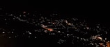 Night view of Ipatinga city's skyline with lights glowing.
