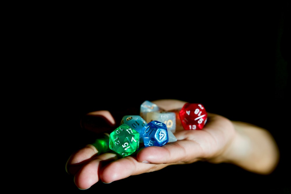 person holding polygonal die