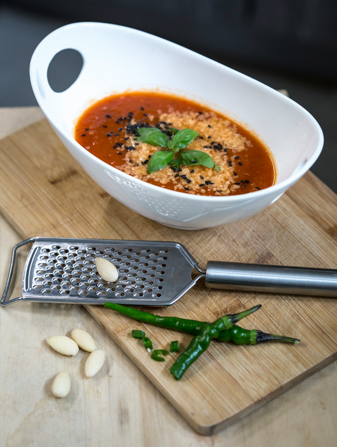 soup in white ceramic bowl beside black and silver iphone 6