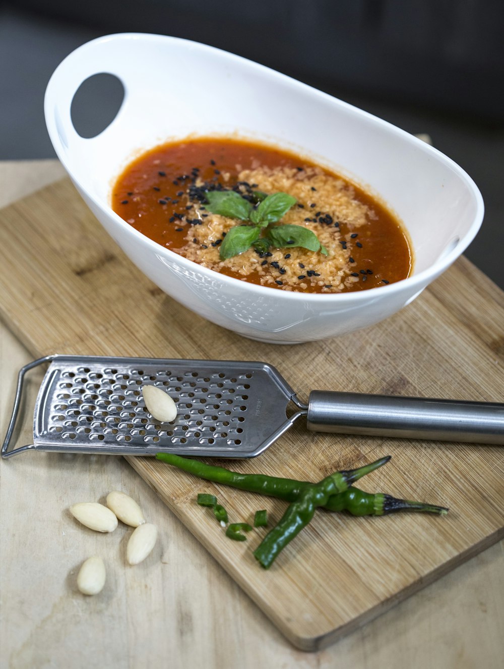 soup in white ceramic bowl beside black and silver iphone 6