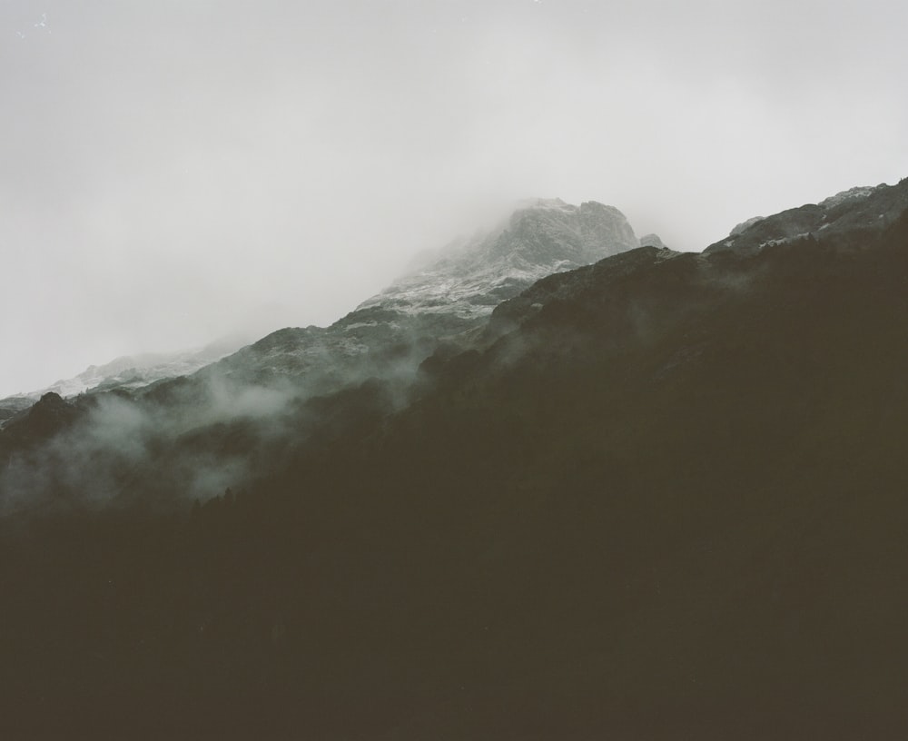 photo of mountain peak covered with fog