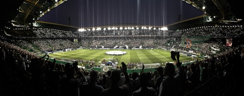 A panoramic shot of a packed stadium under floodlights during a Champions League night.