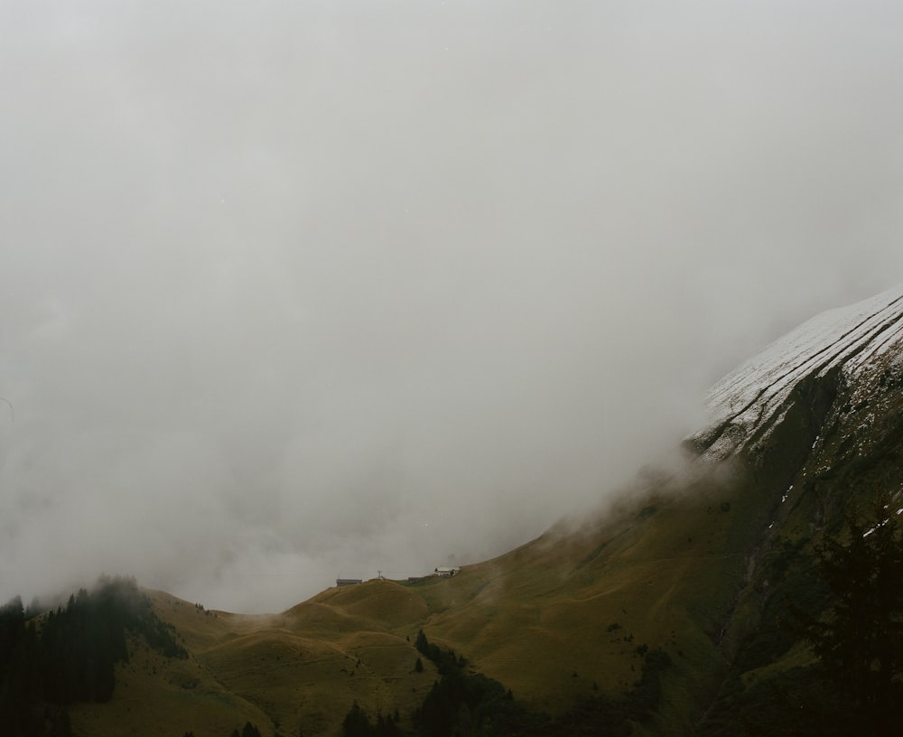 hill during foggy day