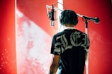 man standing in front of condenser microphone