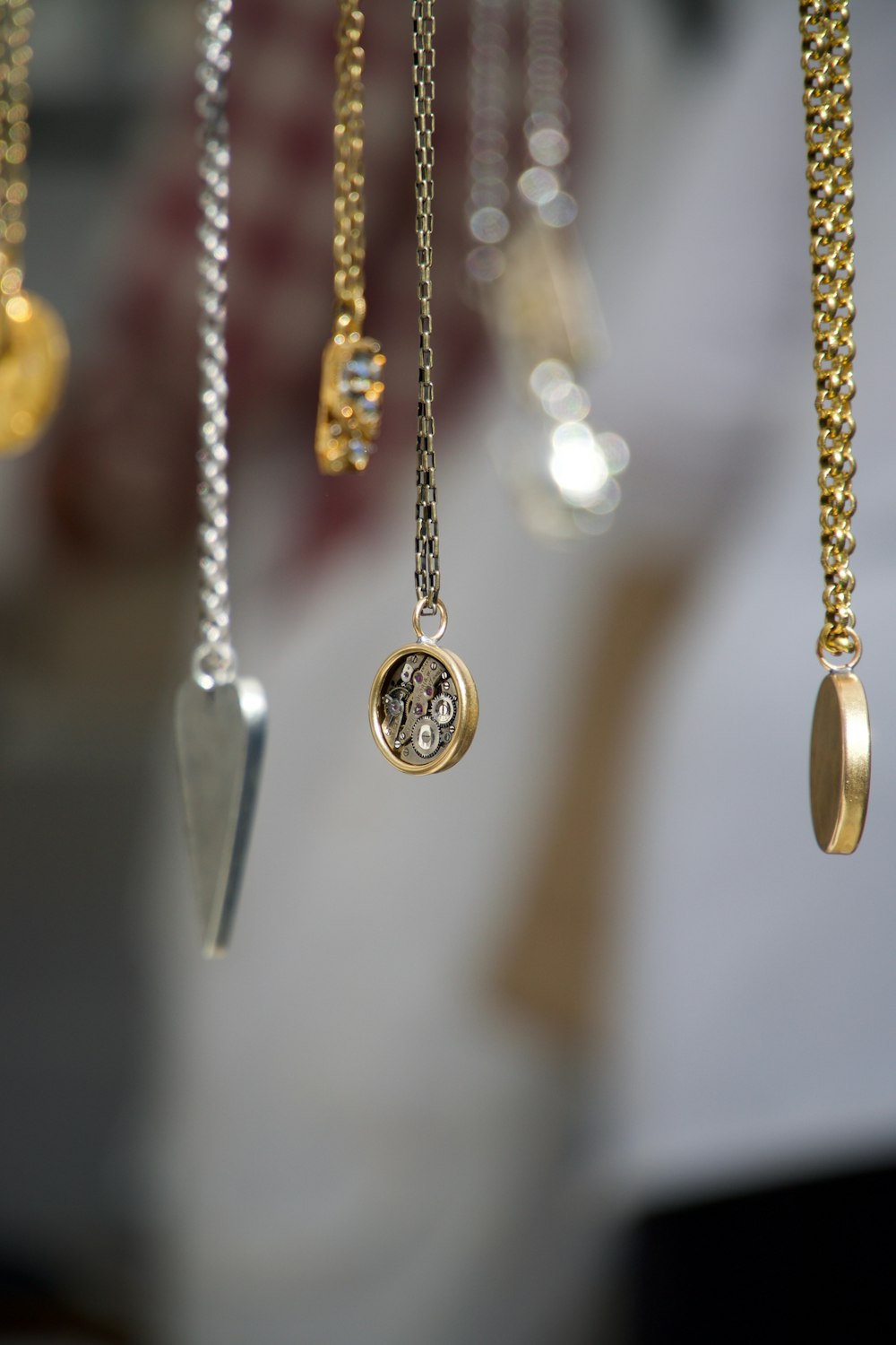 gold-and-silver-colored pendant necklace