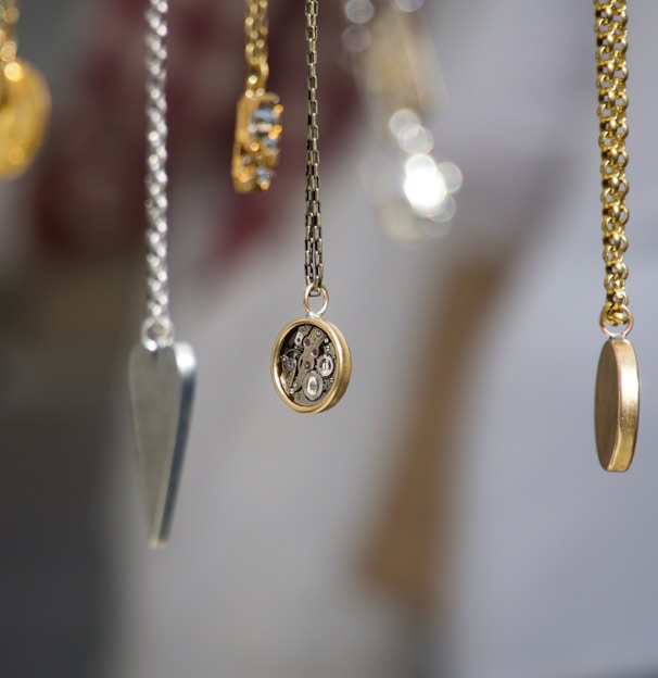 gold-and-silver-colored pendant necklace