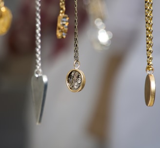 gold-and-silver-colored pendant necklace