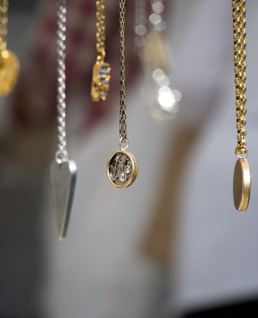 gold-and-silver-colored pendant necklace