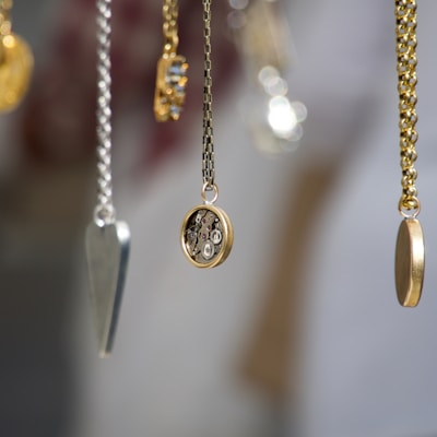 gold-and-silver-colored pendant necklace