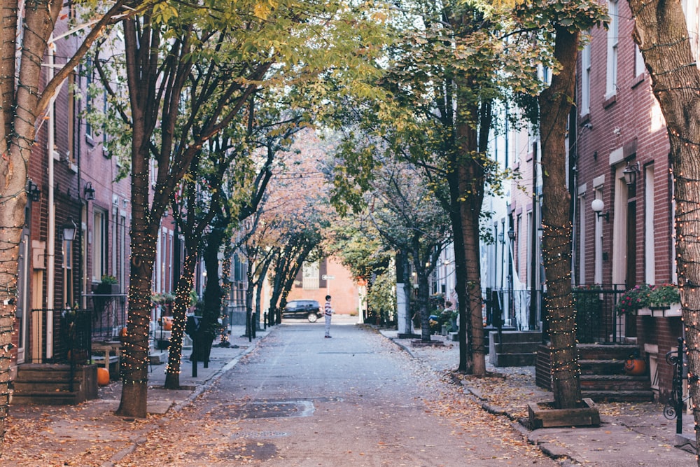 man standing on road