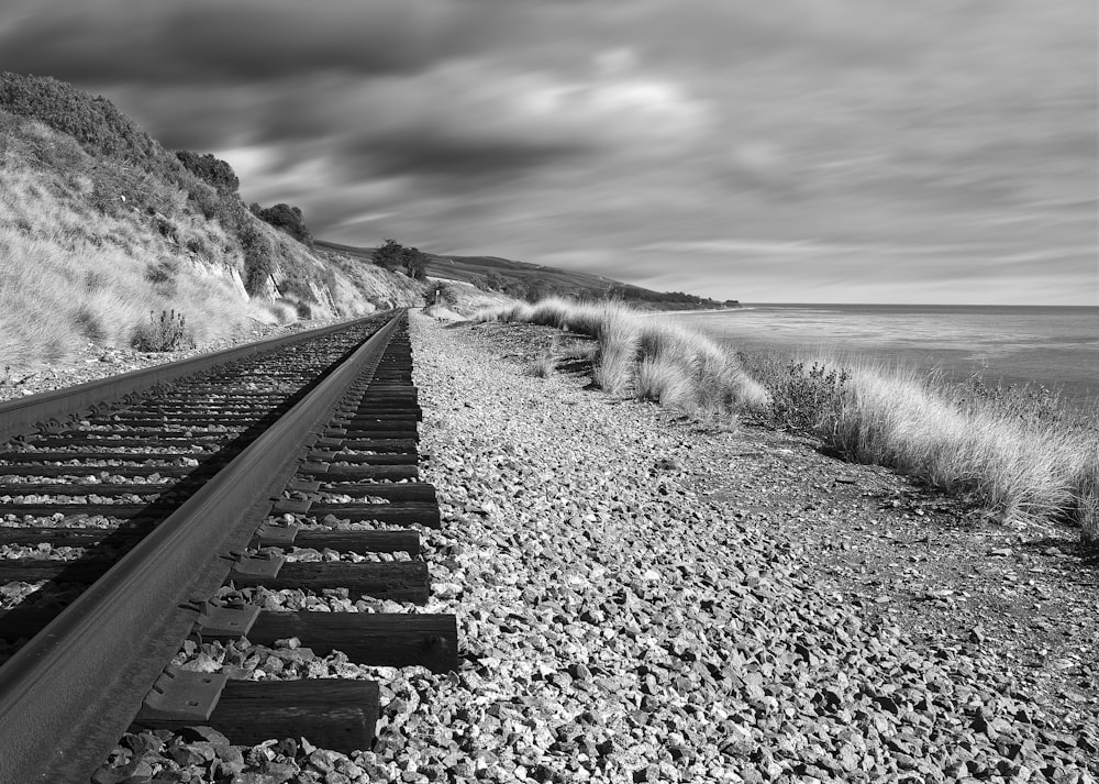 grayscale photo of train rail