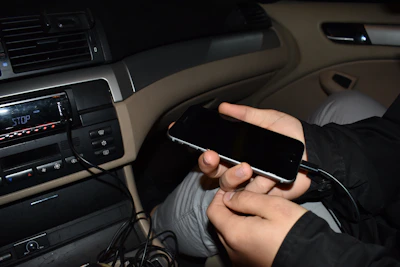 Mobile radio installation inside a car showing neatly arranged cables and radio unit