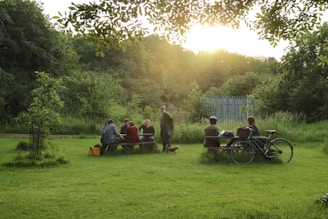 A warm gathering of diverse families smiling and sharing a picnic in a sunny park.