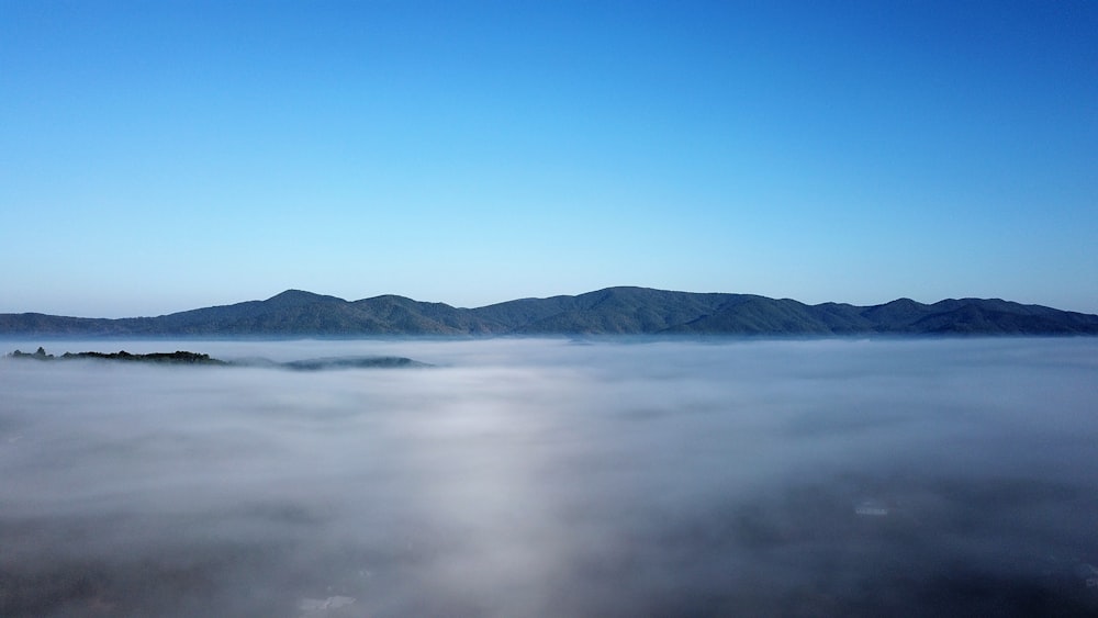 photo of mountain and clouds during daytime