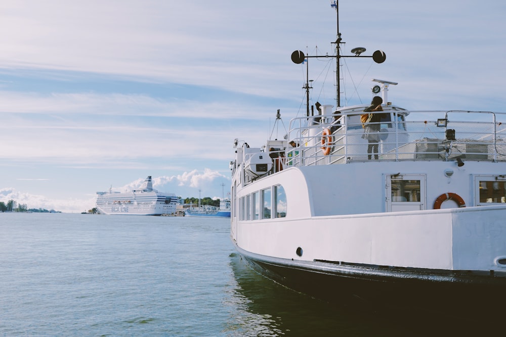 white and black ship on body of water