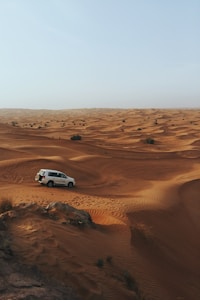 photography of white SUV on desert