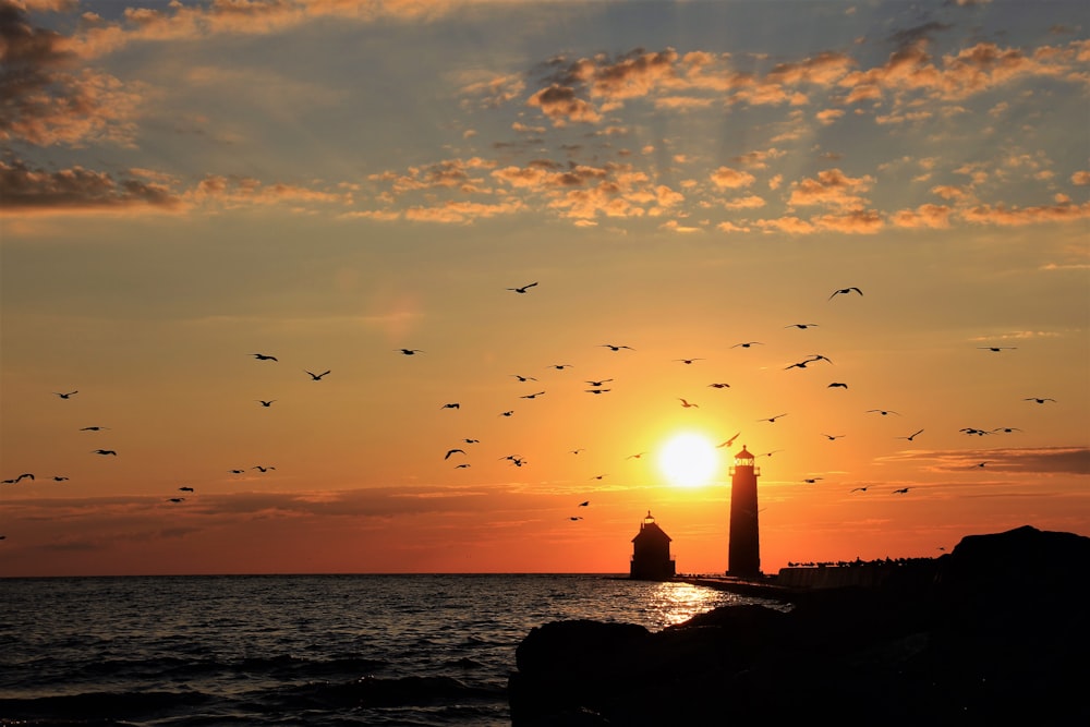 silhouette of lighthouse during sunset