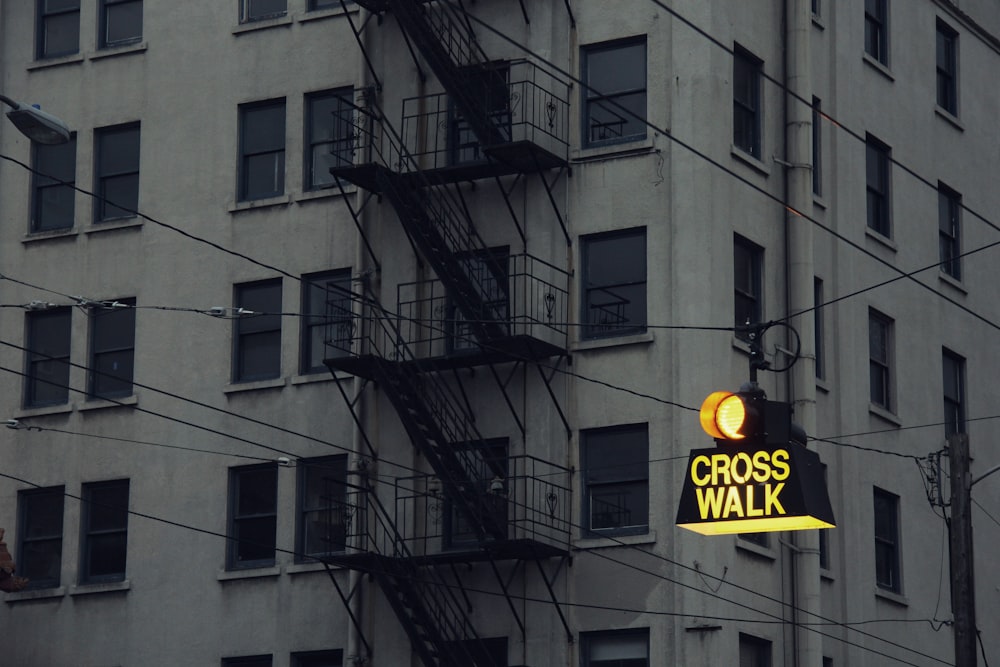 lighted Cross Walk street signage near concrete building