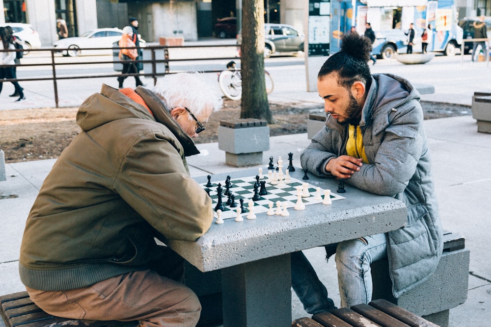 people playing chessboard game outdoor
