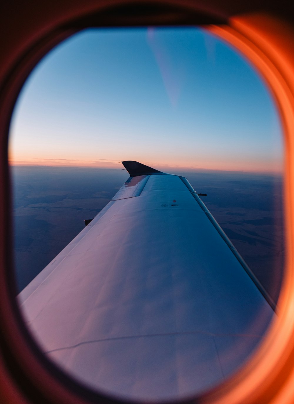 photo of left side airplane wing during daytime