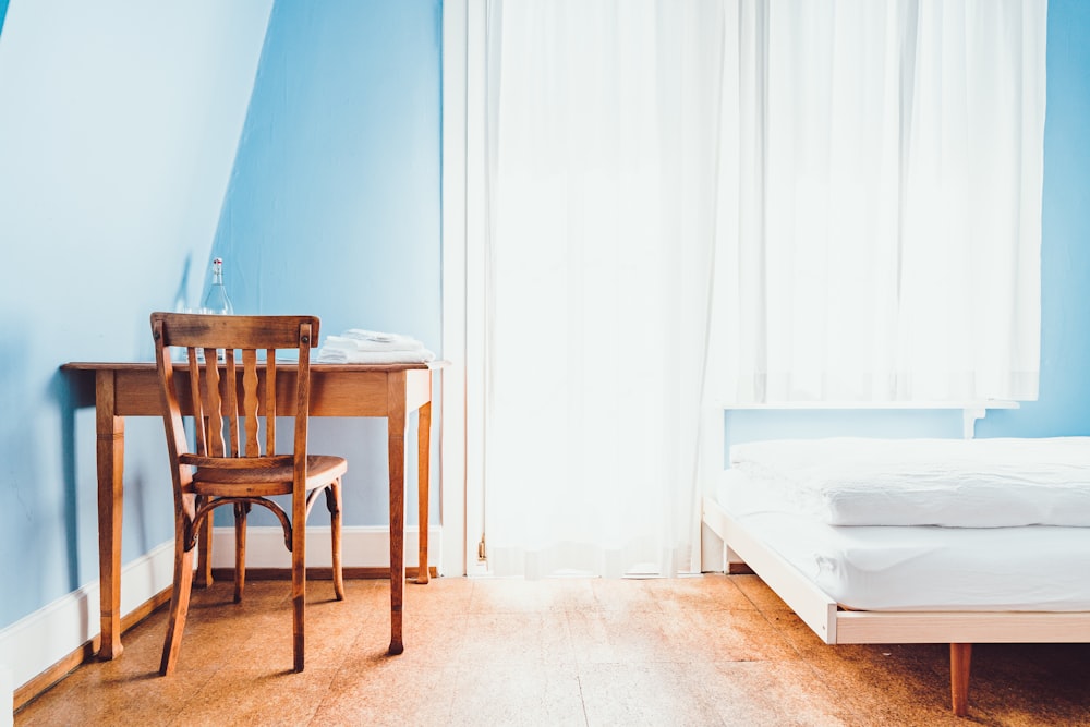 brown wooden chair near mattress