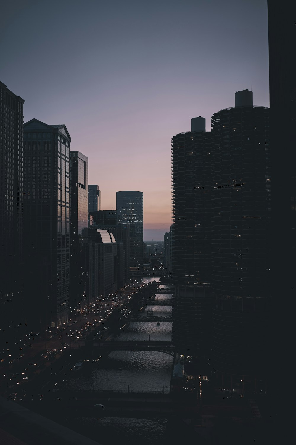 silhouette photo of high rise buildings during nighttime