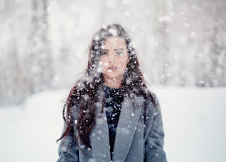 selective focus photograph of woman in gray coat