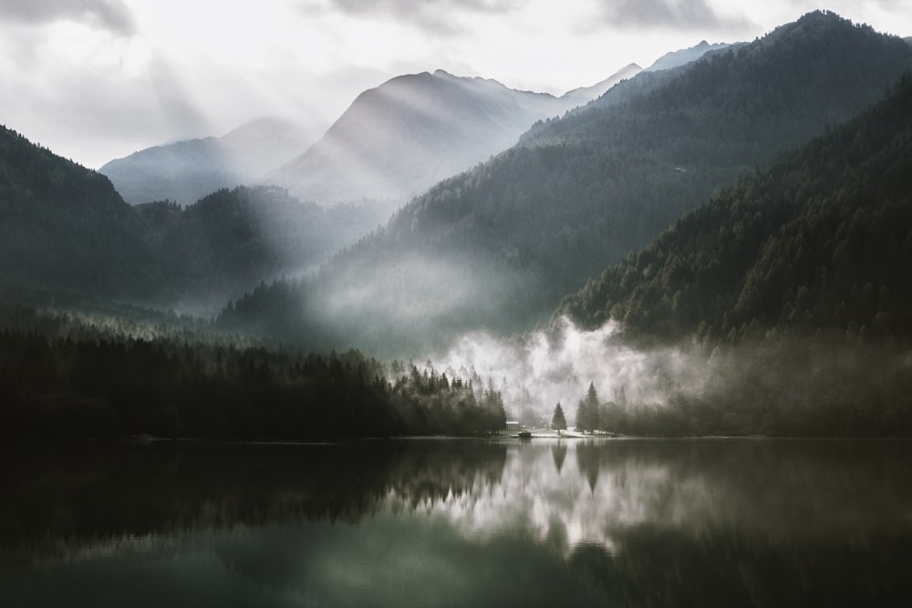 mountain across lake under white sky