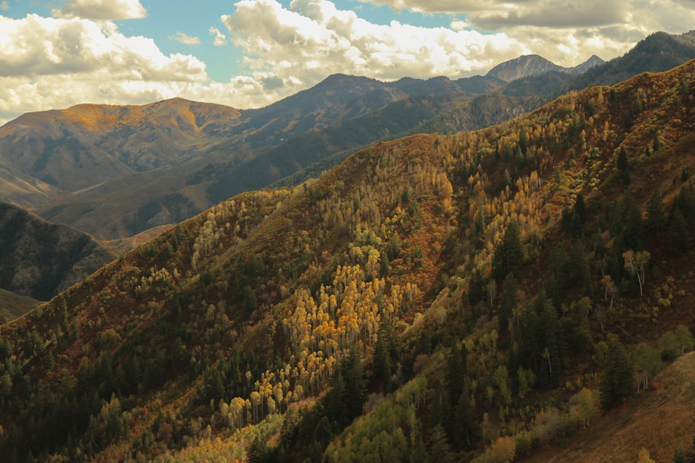 landscape photography of brown mountains under cumulus clouds