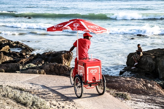 man selling ice cream products in Bloubergstrand South Africa