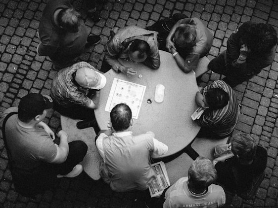 A cozy gathering of vintage game enthusiasts sharing stories around a classic board game.