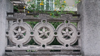 Elegant stamped concrete patio featuring intricate patterns and warm earthy tones surrounded by garden landscaping.