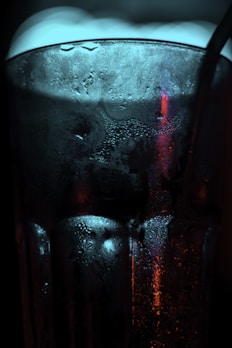 Frosted glass of sparkling hibiscus mead with condensation beads.